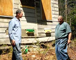 Brother Placid and Gus Skamarycz preparing the bee house.